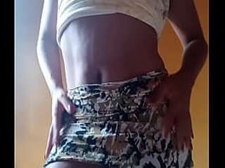 redhead ladyboy in black dress strokes her small cock on table